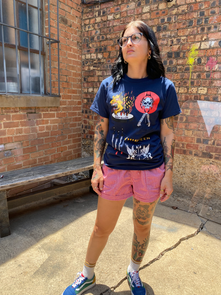monster face, alien skull, bloody daggers, dual pegasus crest printed on a blue t-shirt