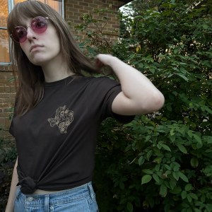 Woman wearing Succulents t-shirt design in gold on black fabric