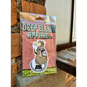 scruffy punk possum wearing a vest that says live free or play dead